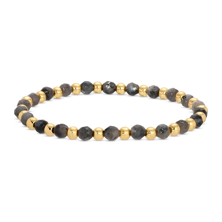 A beaded stretch bracelet featuring faceted dark gray and black beads alternating with polished gold-tone metal beads, displayed on a clean white background.