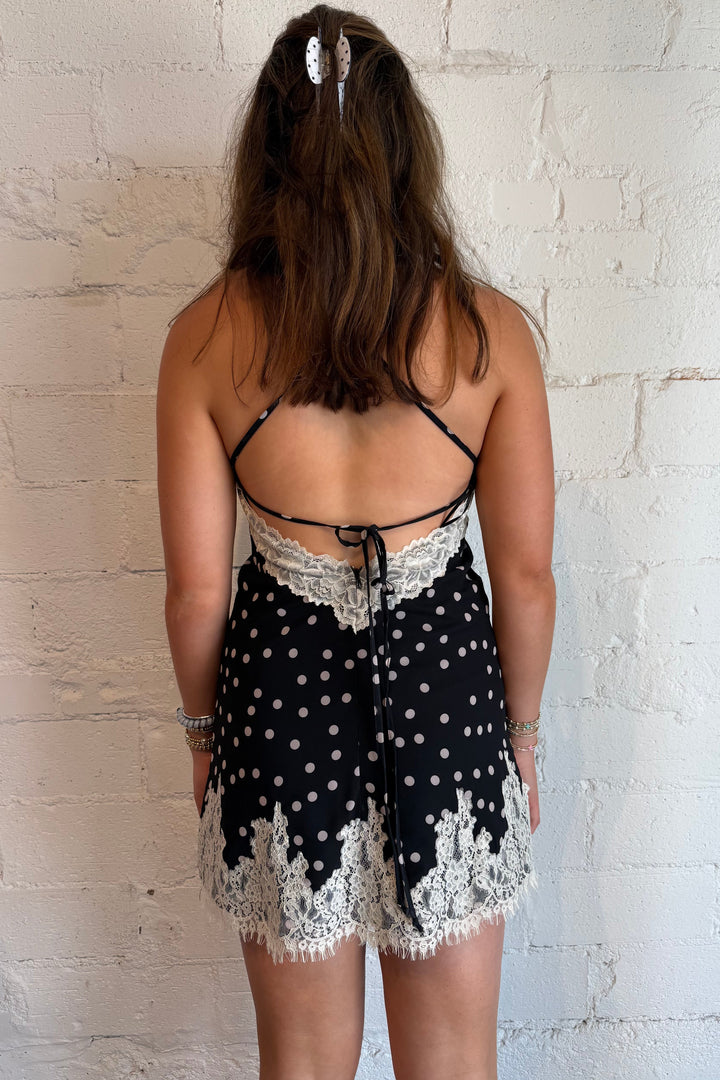 Black polka dot lace mini dress with tie back