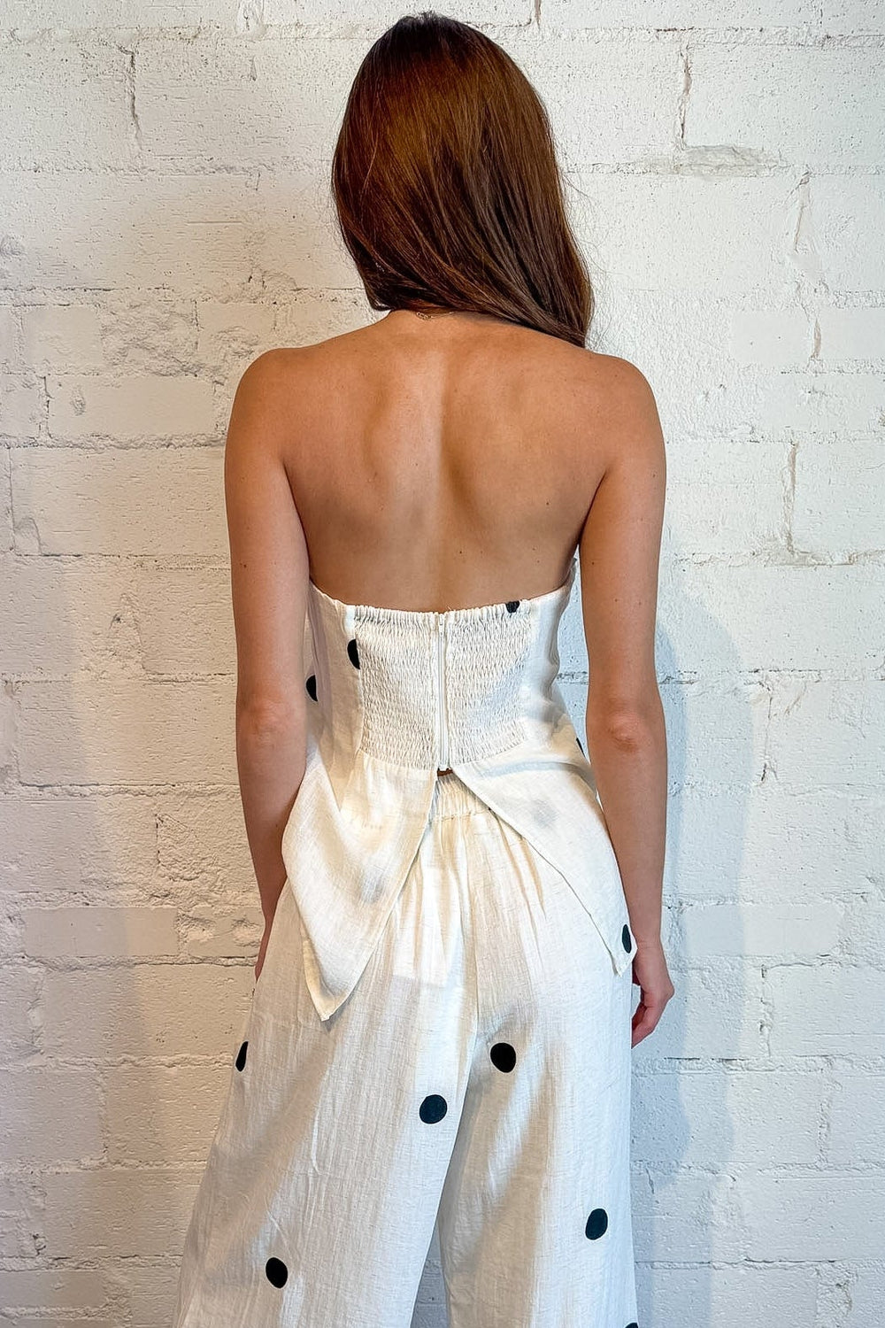 White polka dot pants for women featuring a trendy wide-leg silhouette
